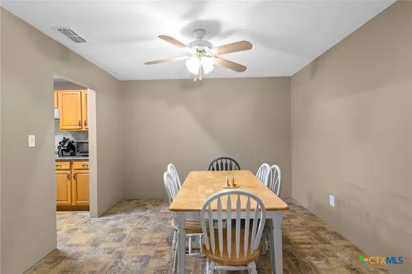 a view of a hallway to a livingroom with furniture