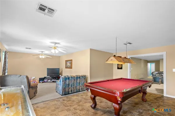 a room with pool table and flat screen tv