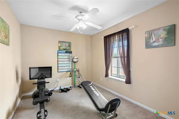 a room with gym equipment and a window