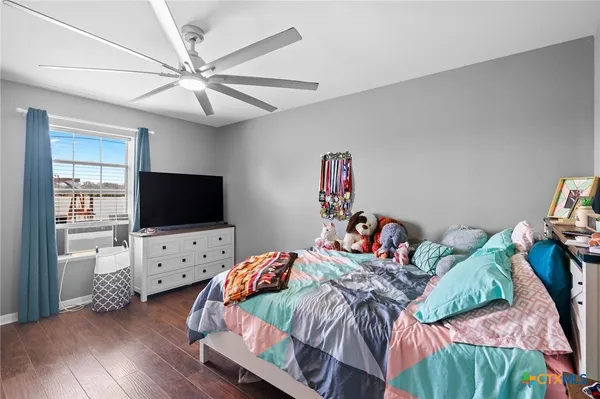 a bedroom with a bed and a flat screen tv