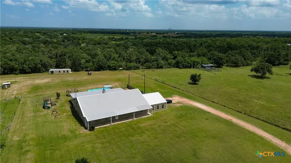 an aerial view of a house with a yard