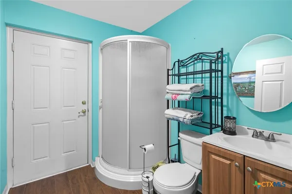 a bathroom with a toilet a sink and mirror