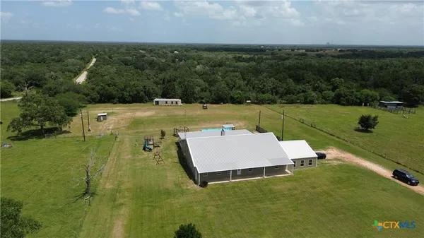 an aerial view of a house with a yard