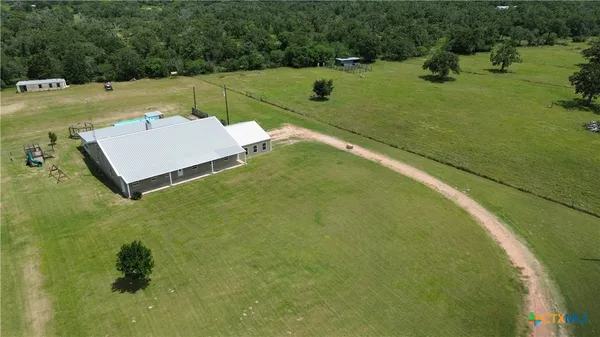 a aerial view of a house with a yard