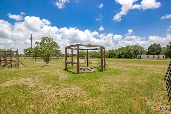 a view of a playground with basketball court