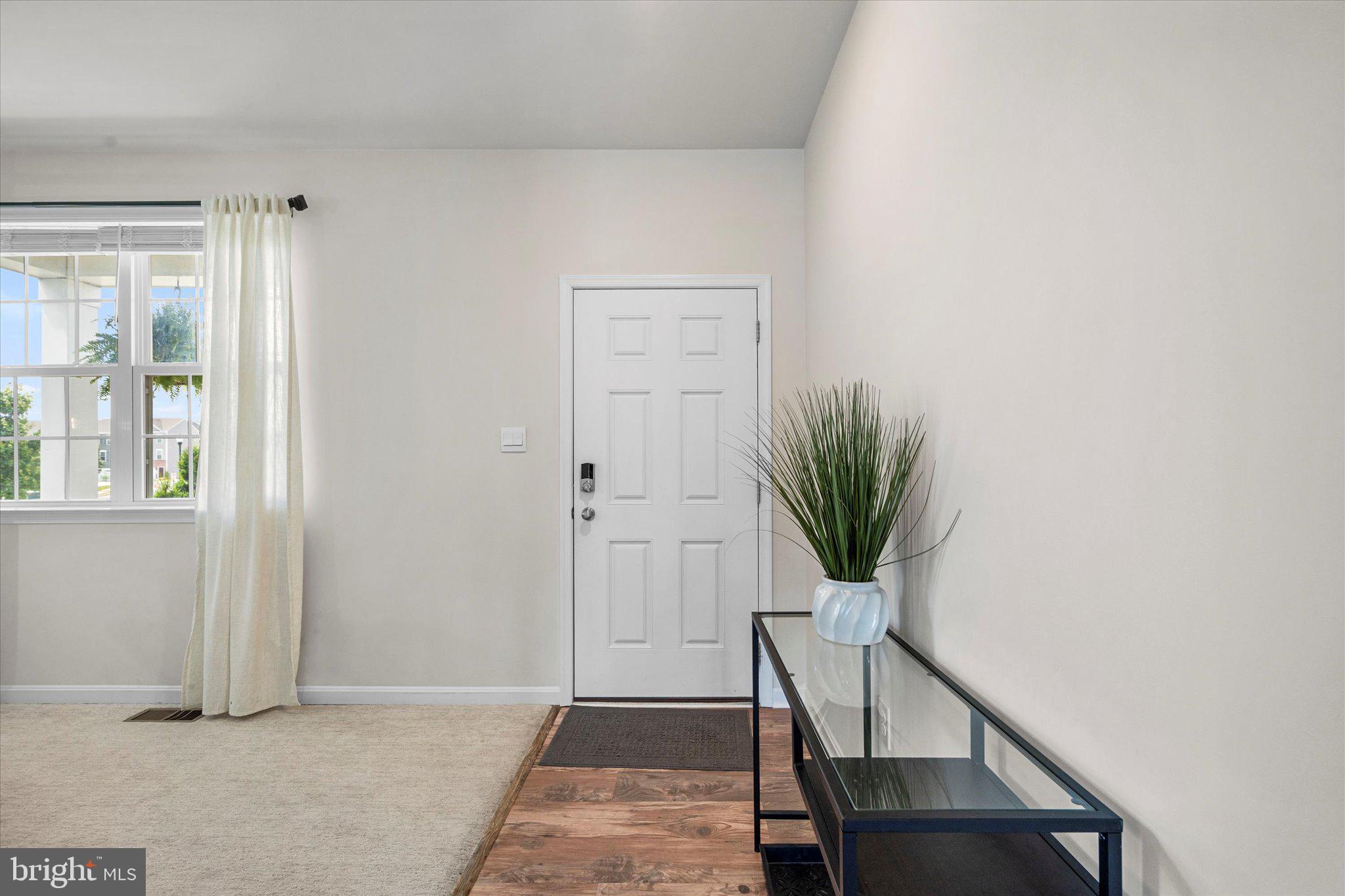 2004 Fauna Drive Frederick, MD 21702 - Photo 13 of 46 a view of a hallway with wooden floor and a potted plant