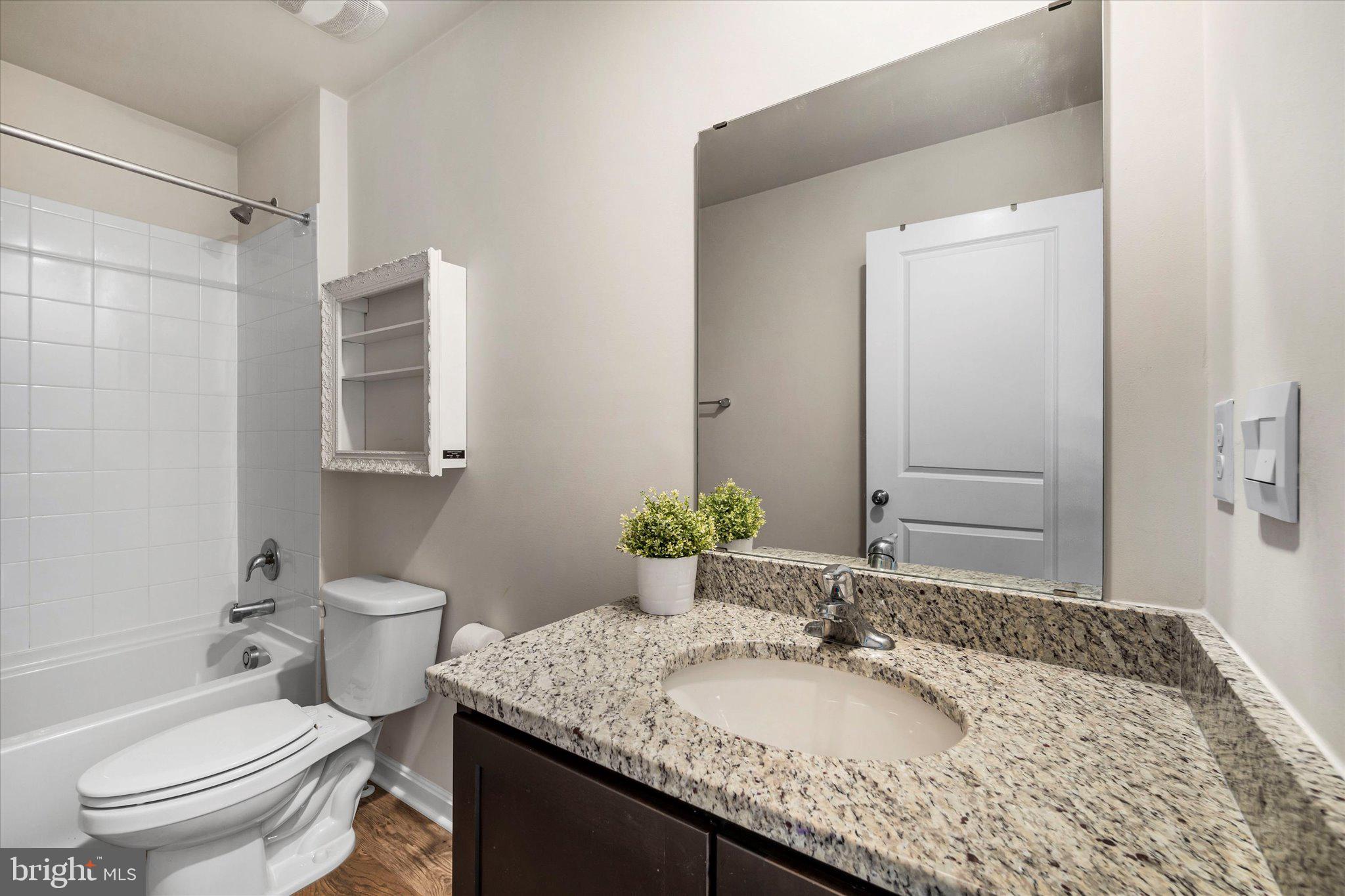 2004 Fauna Drive Frederick, MD 21702 - Photo 16 of 46 a bathroom with a granite countertop sink a toilet and a mirror