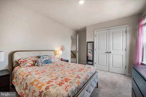 a large bed sitting in a bedroom and closet