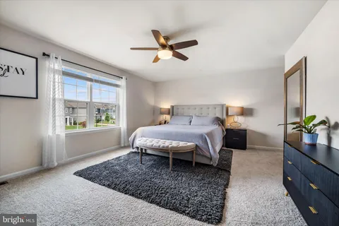 a spacious bedroom with a large bed and a window