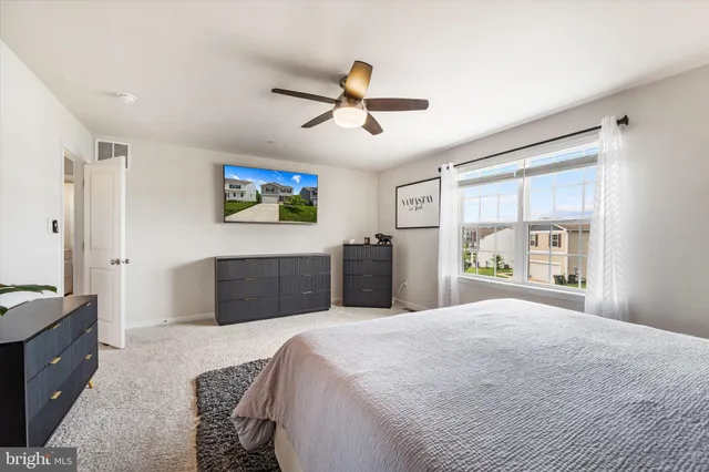 a bedroom with a large bed and a window