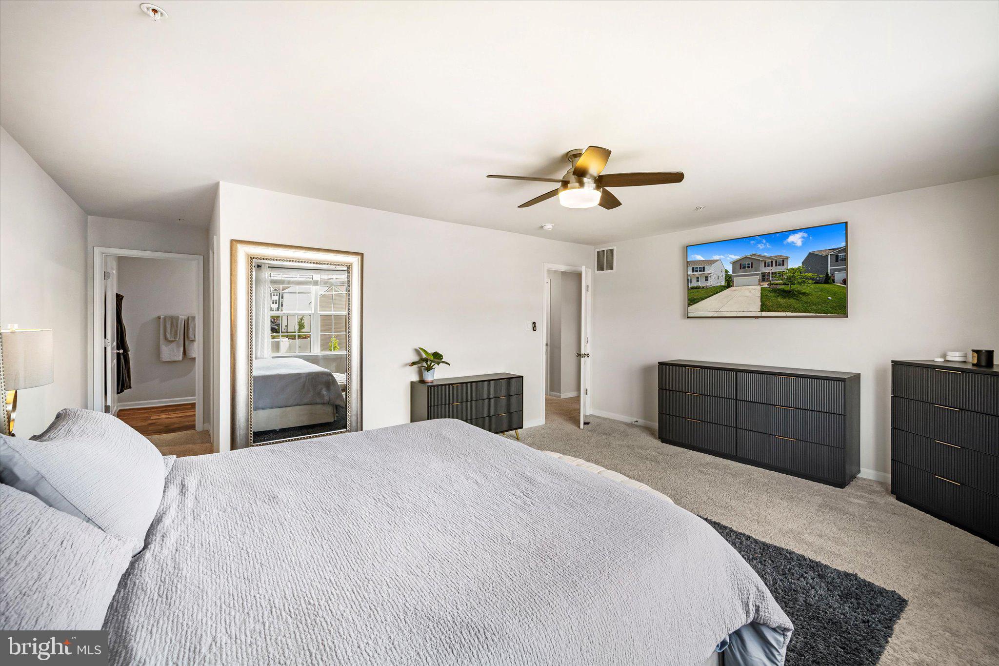 2004 Fauna Drive Frederick, MD 21702 - Photo 21 of 46 a bedroom with a large bed and a chandelier