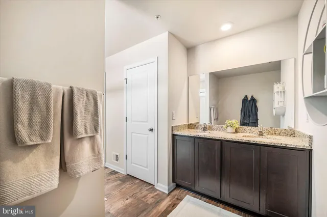 a bathroom with a double vanity sink and a mirror