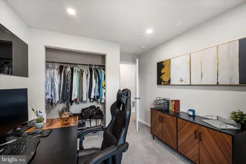 a view of a workspace with furniture and a window