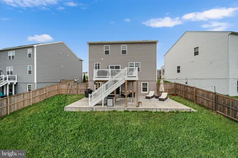 a view of a house with a backyard porch and sitting area