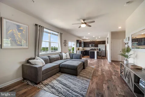 a living room with furniture and a large window