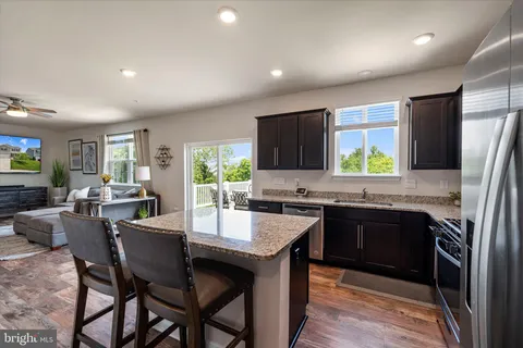a kitchen with granite countertop appliances cabinets and furniture