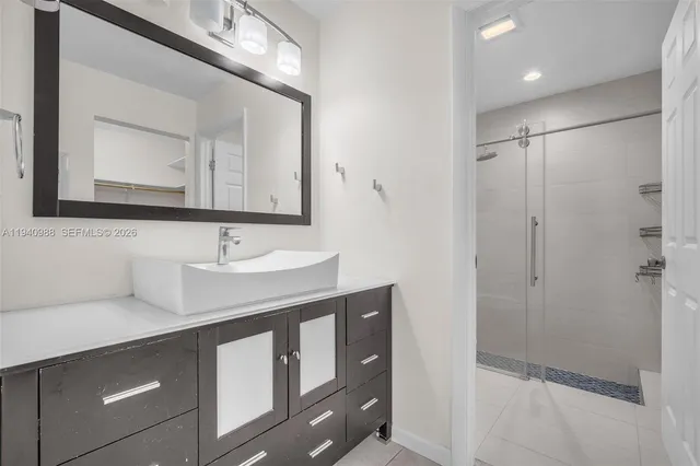 a bathroom with a shower toilet and sink