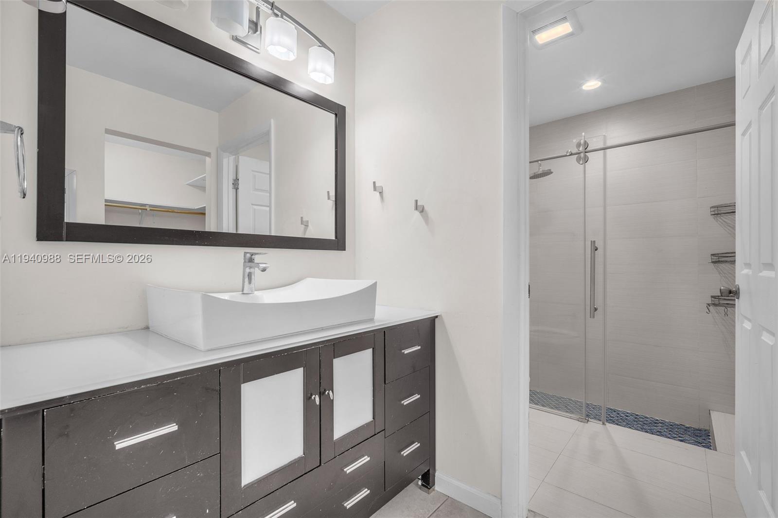 11125 Southwest 134th Court Miami, FL 33186 - Photo 17 of 33 a bathroom with a double vanity sink mirror and