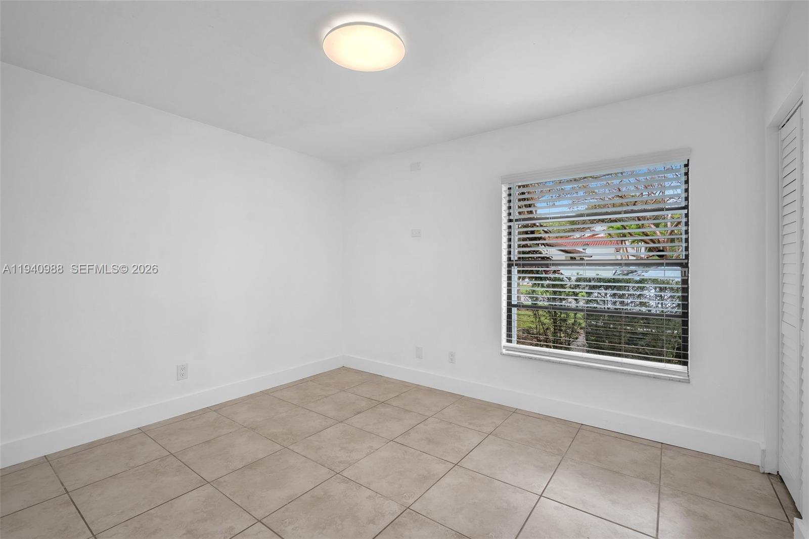 11125 Southwest 134th Court Miami, FL 33186 - Photo 20 of 33 an empty room with a window