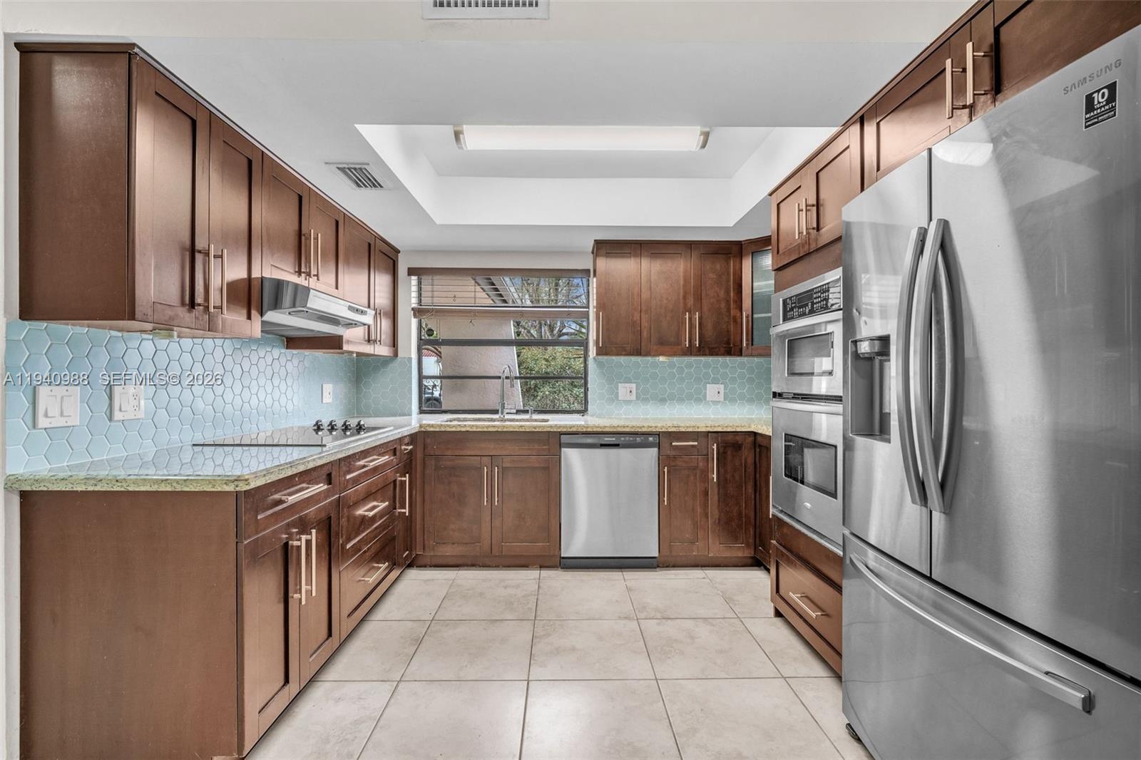 11125 Southwest 134th Court Miami, FL 33186 - Photo 5 of 33 a kitchen with stainless steel appliances granite countertop a refrigerator and a sink