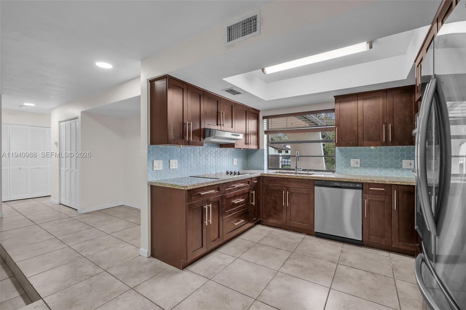 11125 Southwest 134th Court Miami, FL 33186 - Photo 7 of 33 a large kitchen with stainless steel appliances granite countertop a stove and a sink