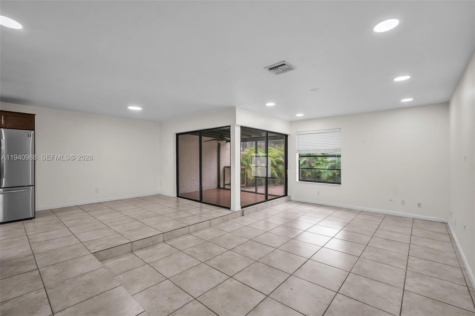 11125 Southwest 134th Court Miami, FL 33186 - Photo 9 of 33 a view of an empty room with a window