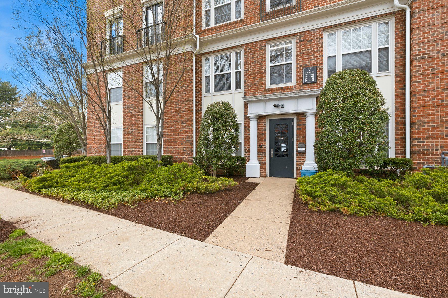 front view of a brick house with a yard
