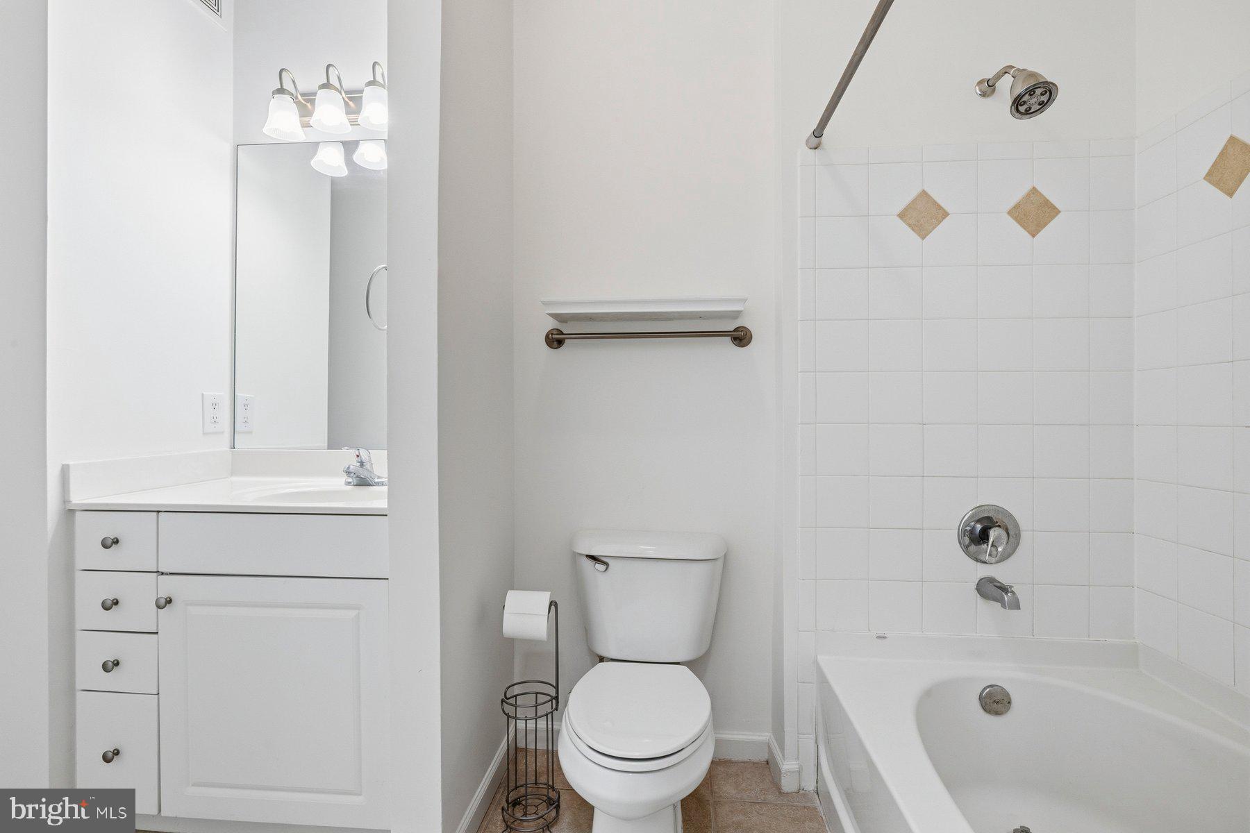 7 Booth Street, Unit 109 Gaithersburg, MD 20878 - Photo 17 of 28 a bathroom with a sink a toilet and shower