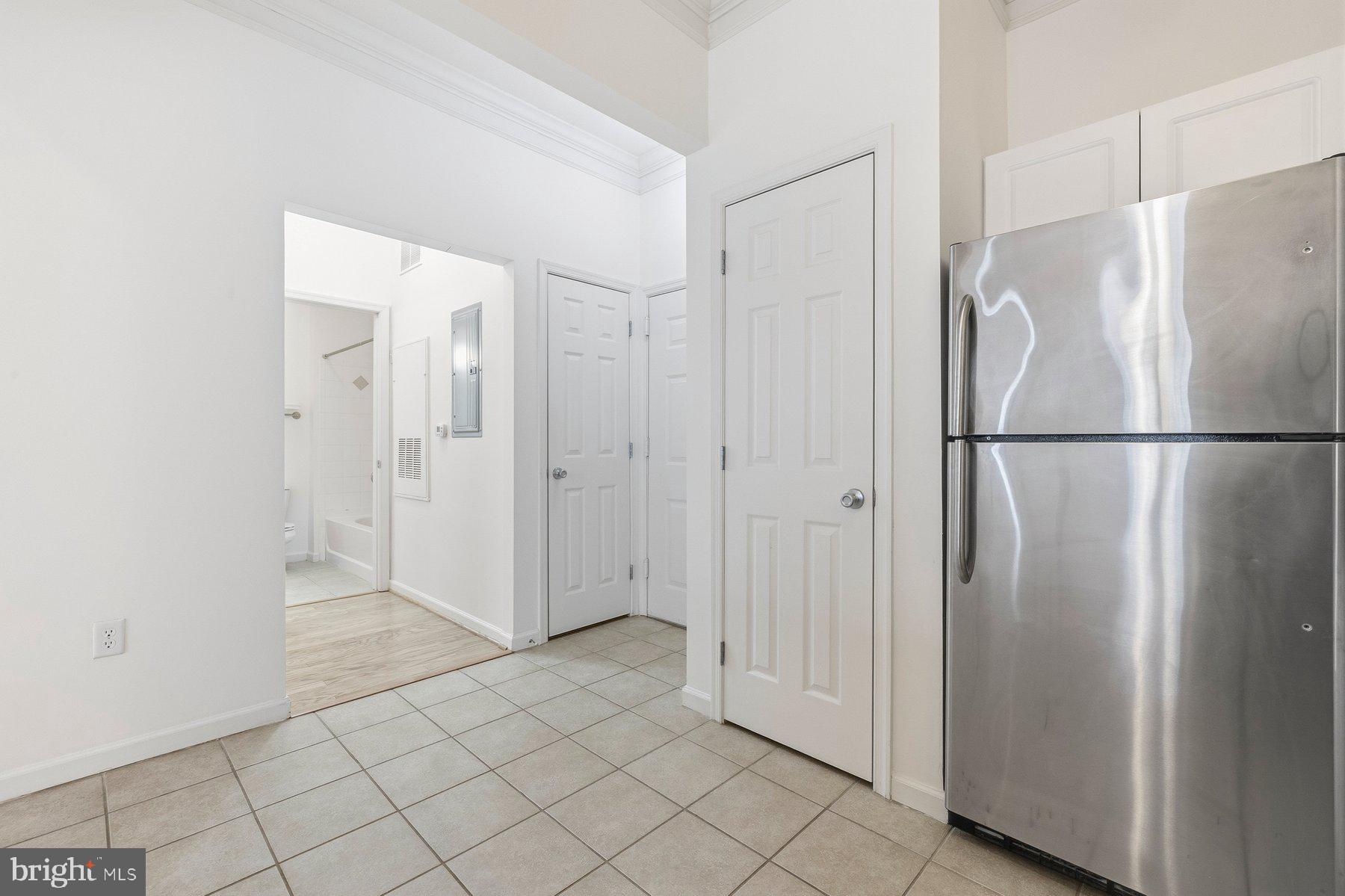 7 Booth Street, Unit 109 Gaithersburg, MD 20878 - Photo 10 of 28 a view of a refrigerator in kitchen and white cabinets