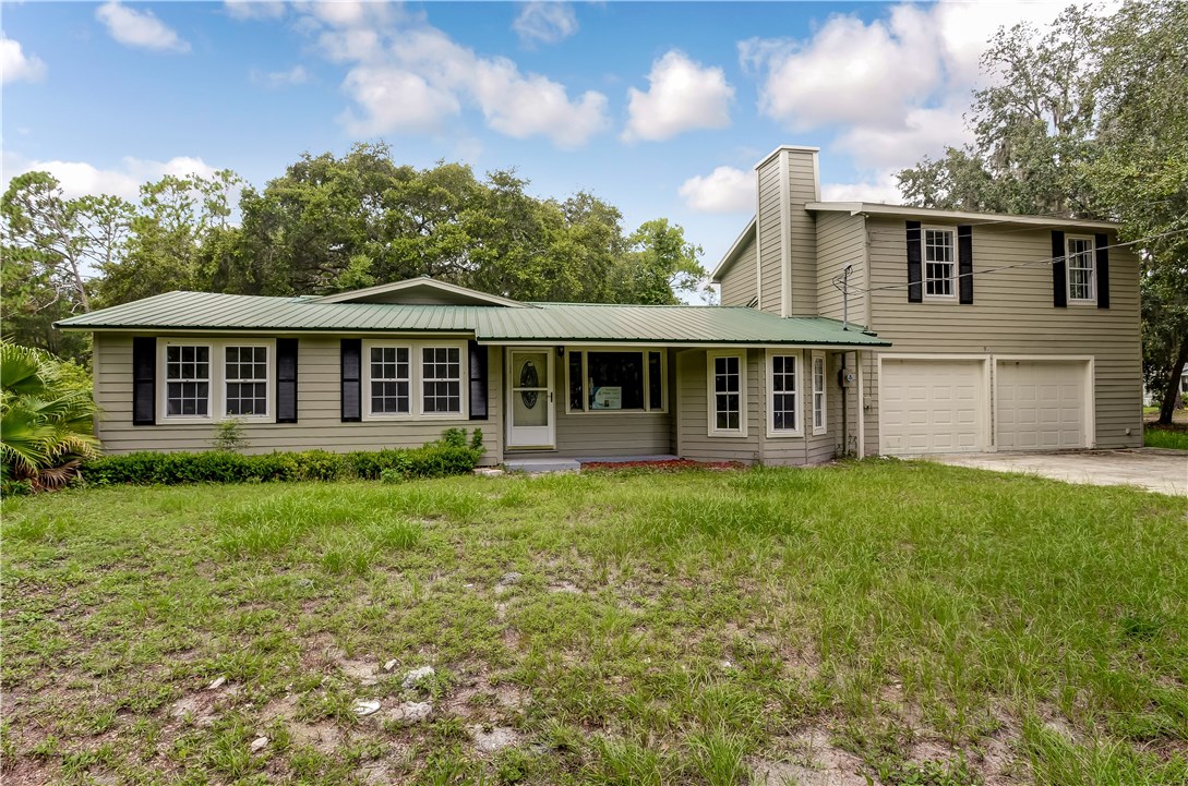 96231 Willyoung Road Yulee, FL 32097 - Photo 1 of 24 a view of a house with a backyard