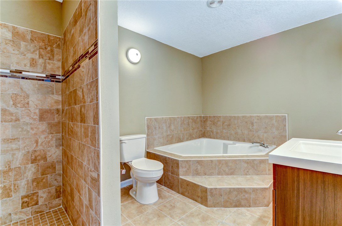 96231 Willyoung Road Yulee, FL 32097 - Photo 11 of 24 a bathroom with a bathtub and toilet