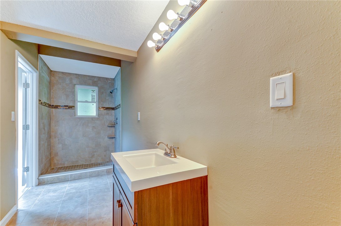 96231 Willyoung Road Yulee, FL 32097 - Photo 15 of 24 a bathroom with a sink a mirror and a shower