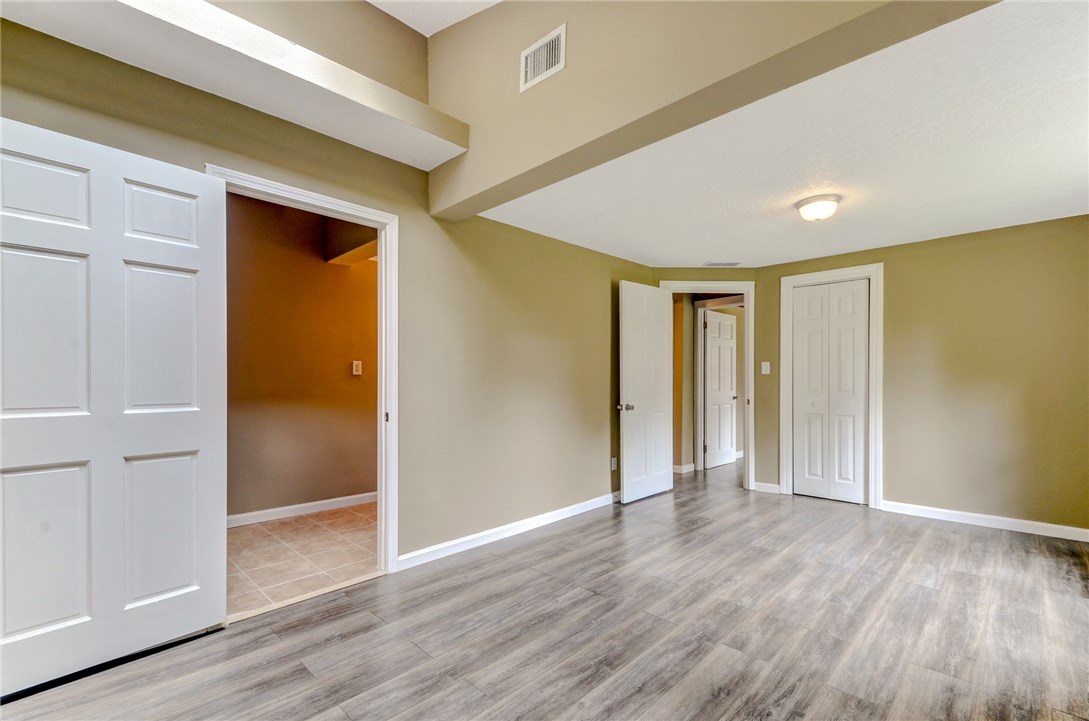 96231 Willyoung Road Yulee, FL 32097 - Photo 16 of 24 wooden floor in an empty room with a window