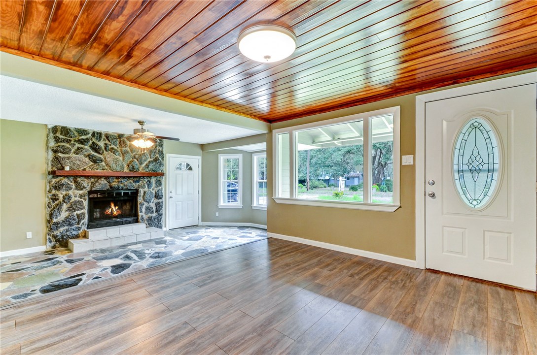 96231 Willyoung Road Yulee, FL 32097 - Photo 2 of 24 a view of an empty room with a fireplace and a window