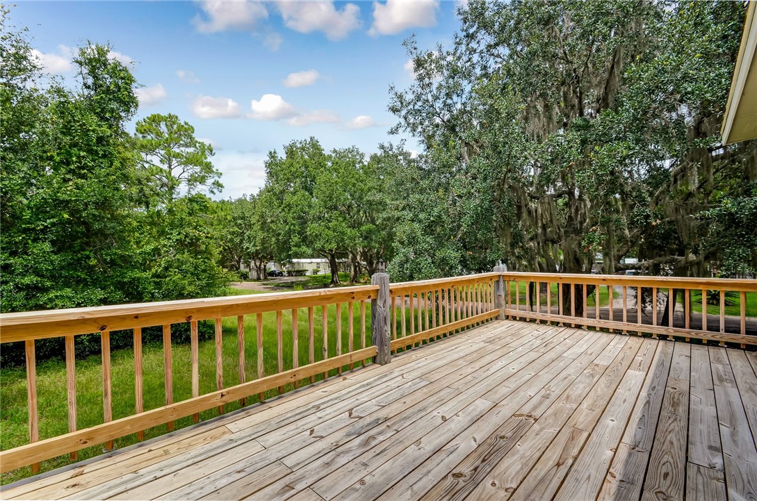 96231 Willyoung Road Yulee, FL 32097 - Photo 23 of 24 a view of balcony with wooden floor and fence