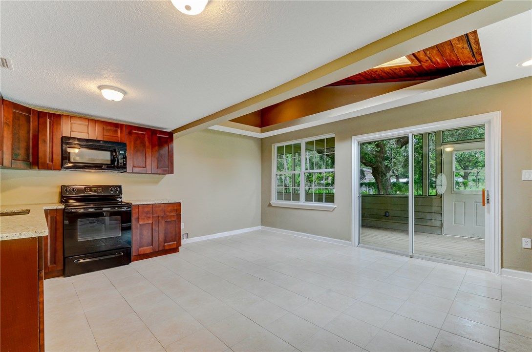 96231 Willyoung Road Yulee, FL 32097 - Photo 4 of 24 a open kitchen with stainless steel appliances granite countertop a refrigerator stove top oven a sink and dishwasher