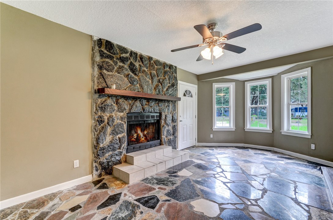 96231 Willyoung Road Yulee, FL 32097 - Photo 8 of 24 a view of livingroom with window fireplace and a chandelier