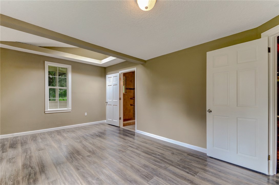 96231 Willyoung Road Yulee, FL 32097 - Photo 9 of 24 an empty room with wooden floor and windows