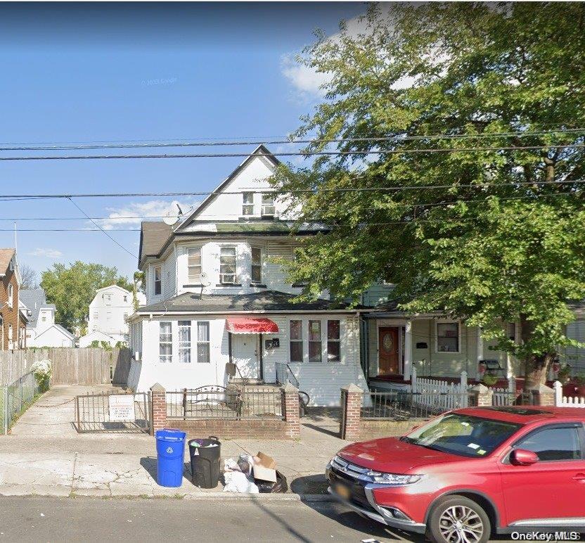 a front view of a house with car parked