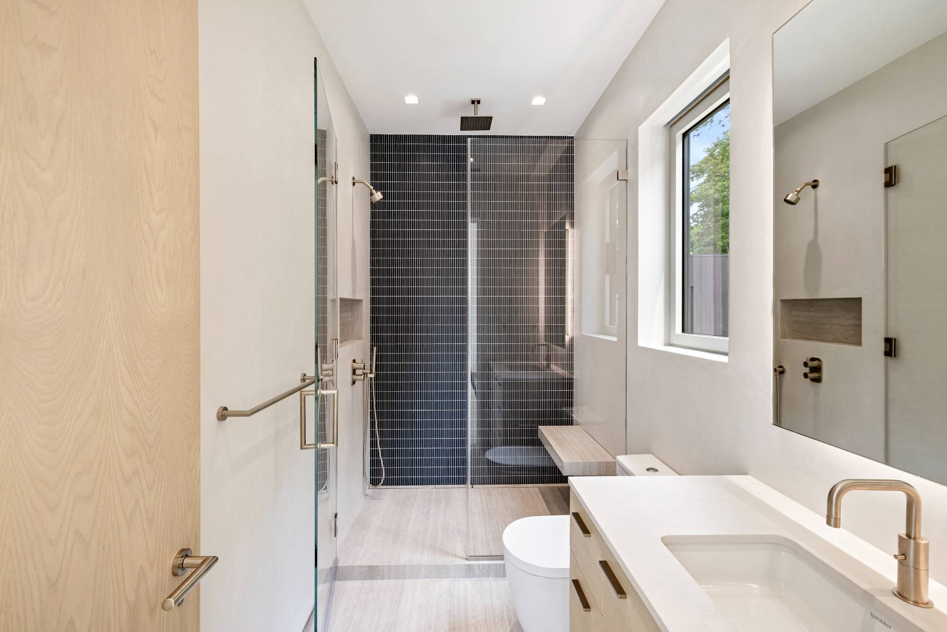 10 Mill Path Bridgehampton, NY 11963 - Photo 30 of 46 a bathroom with a toilet sink and shower