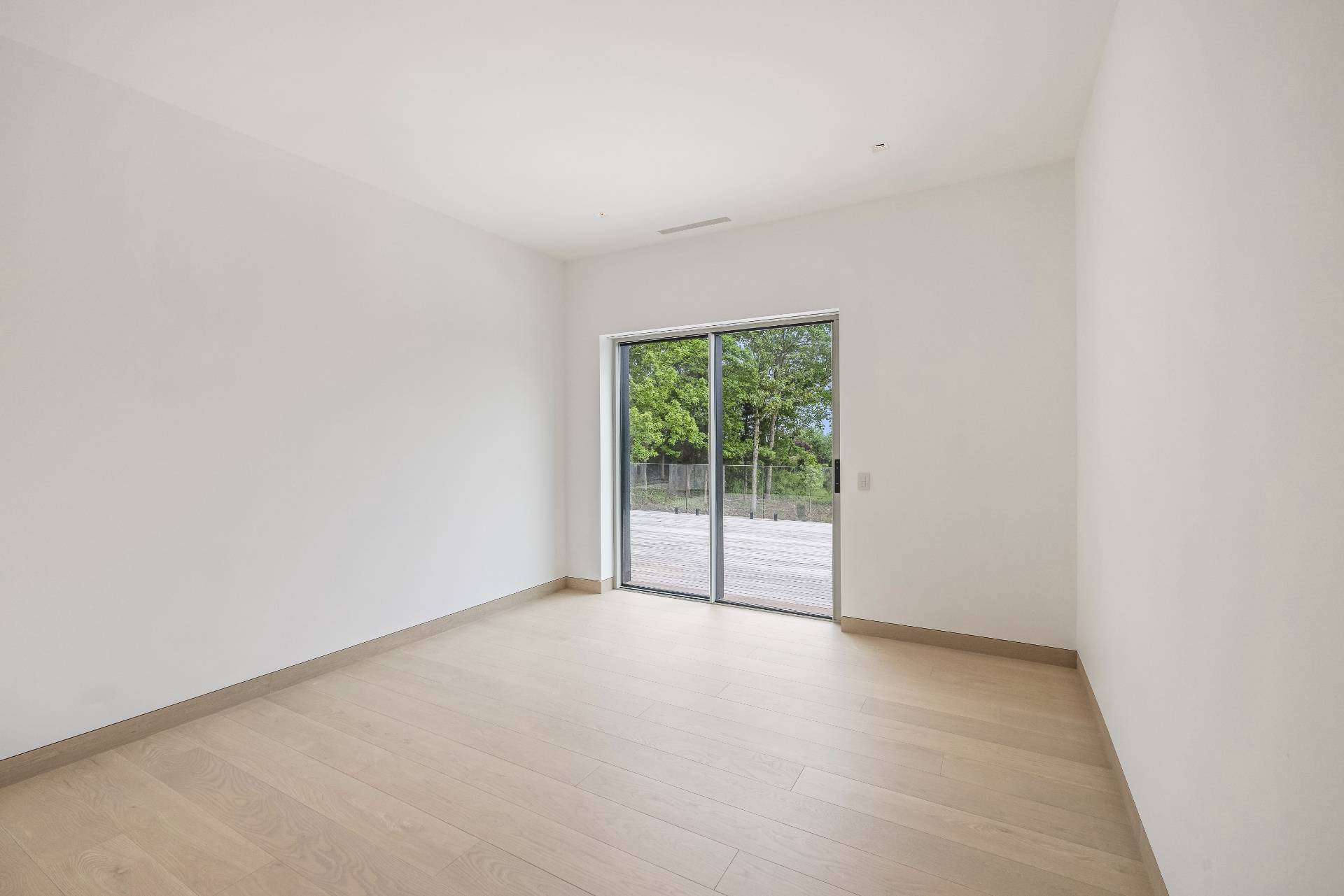 10 Mill Path Bridgehampton, NY 11963 - Photo 31 of 46 an empty room with wooden floor and windows