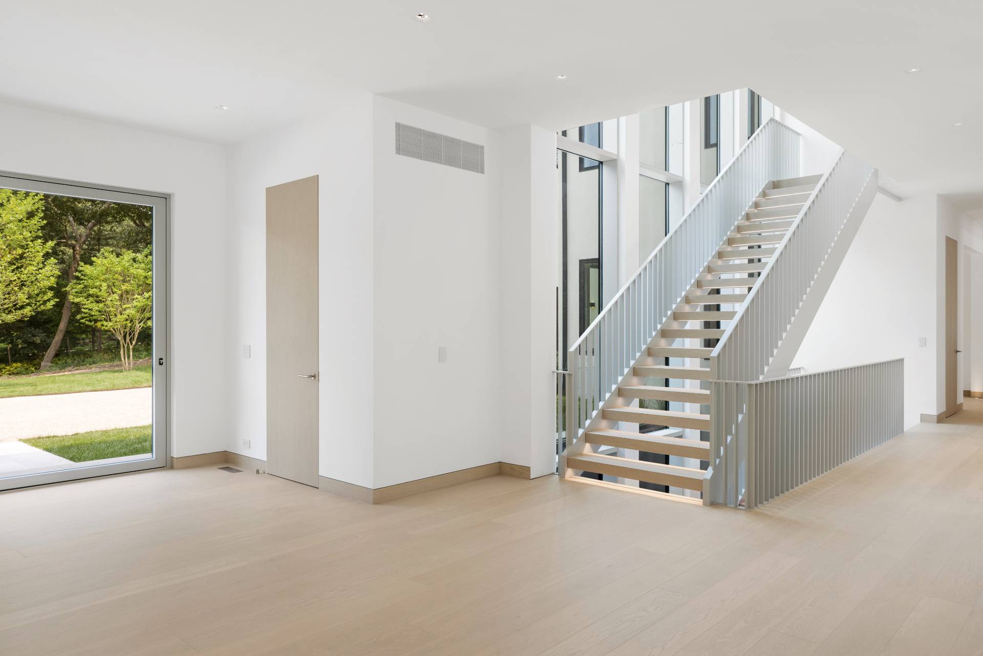 10 Mill Path Bridgehampton, NY 11963 - Photo 6 of 46 a view of an empty room with stairs and white walls