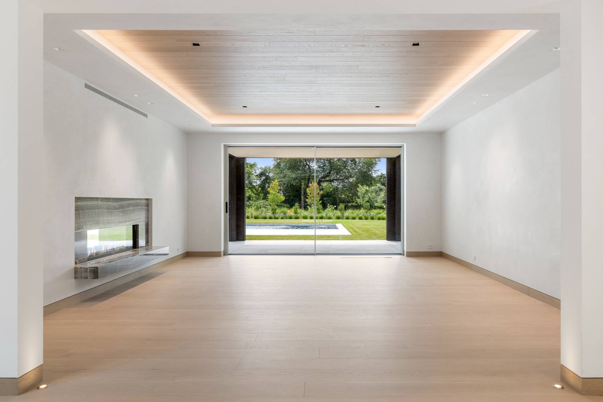 10 Mill Path Bridgehampton, NY 11963 - Photo 9 of 46 an empty room with windows and fireplace