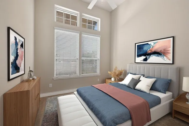 a bedroom with a bed and a painting on the wall