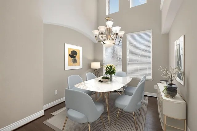 a view of a dining room with furniture and chandelier