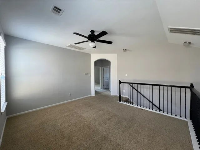 a view of a livingroom with a ceiling fan and window
