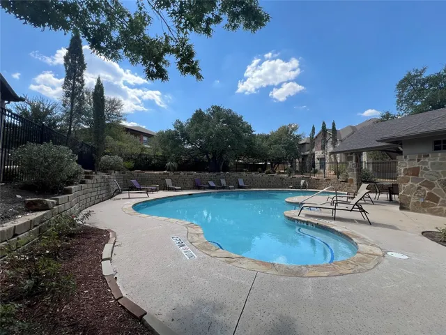 a view of a swimming pool with a patio