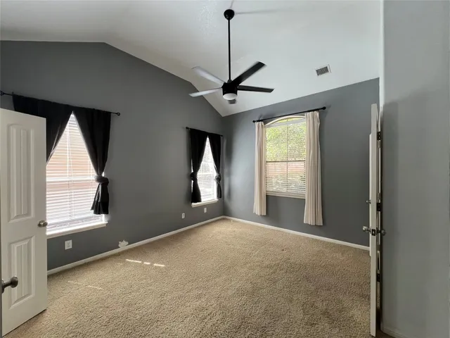 a view of a livingroom with a window and a ceiling fan
