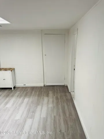 a view of a room with wooden floor