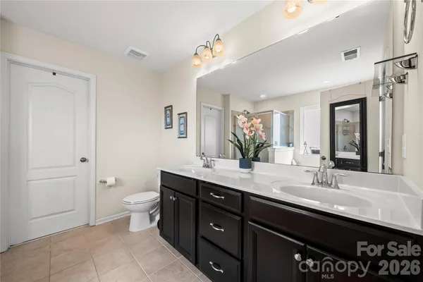 a bathroom with a double vanity sink and a mirror